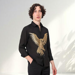 Man wearing a black shirt with a gold eagle design on a white background